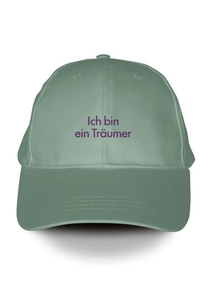 Salbeigrüne Penguin Klassiker Cap mit lila gestickter Schrift. 'Ich bin ein Träumer' Fjodor Dostojewski